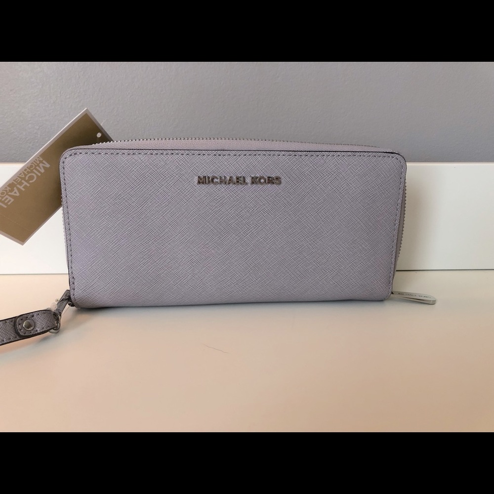 New light purple Michael Kors wrist wallet.